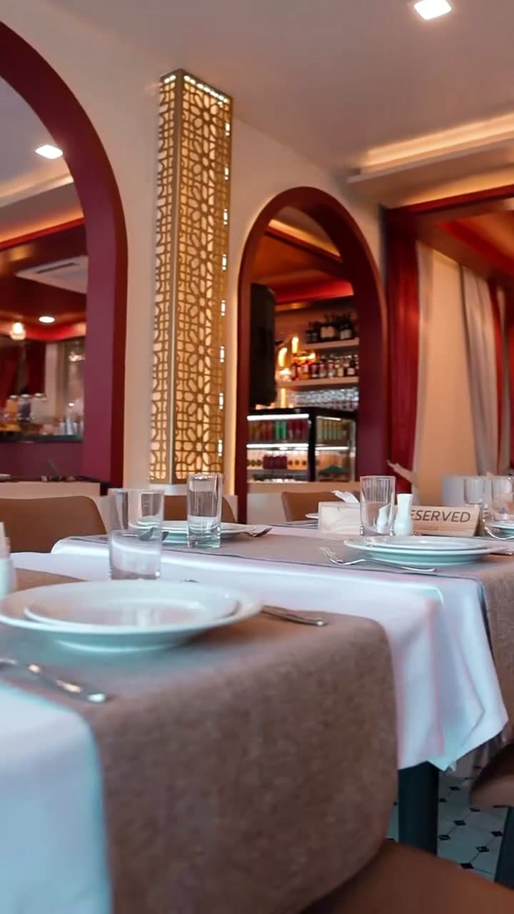 Elegant dining room with arches and golden columns